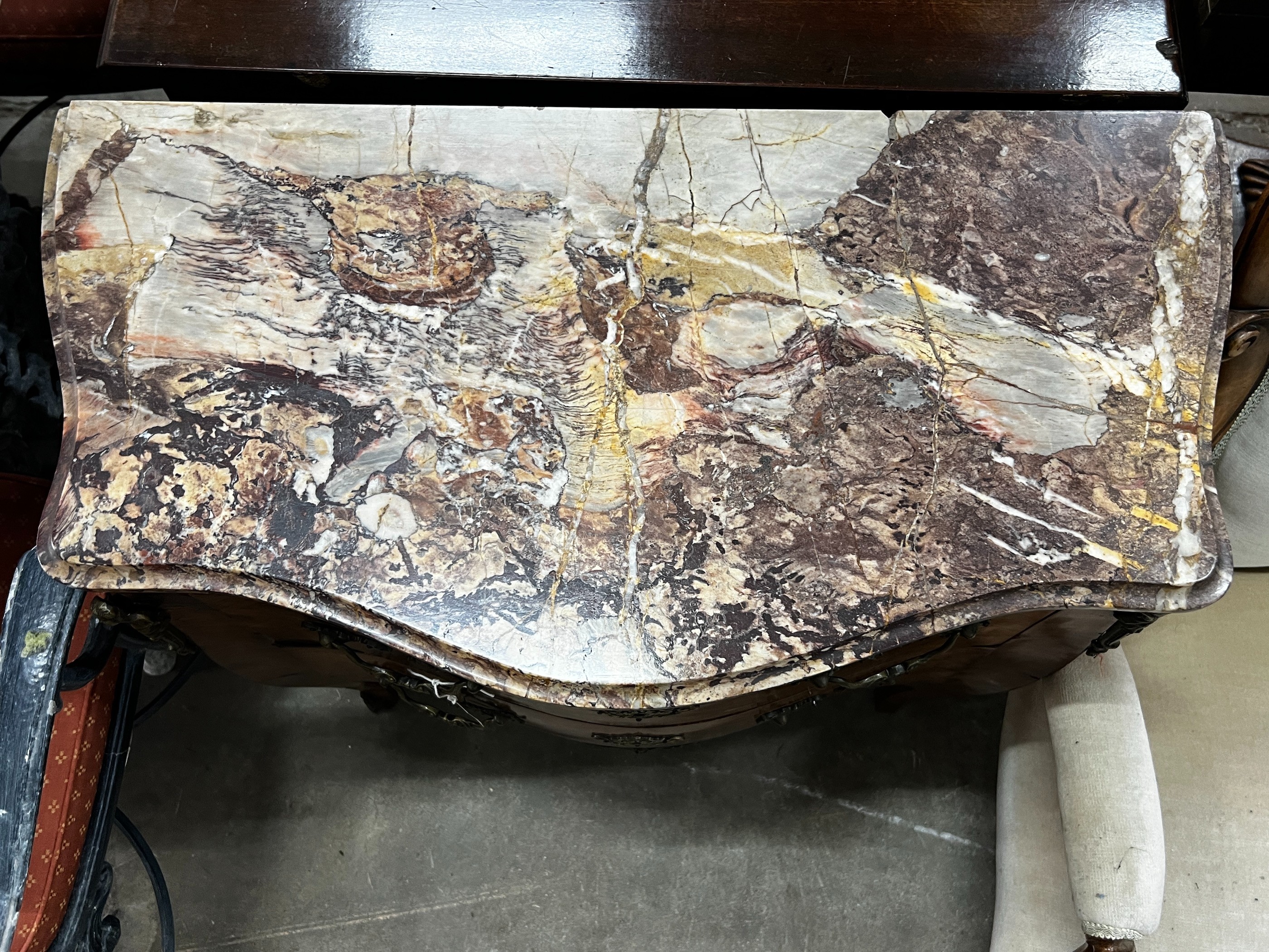 A small 19th century French transitional style gilt metal mounted kingwood marble topped two drawer serpentine commode, width 78cm, depth 39cm, height 75cm